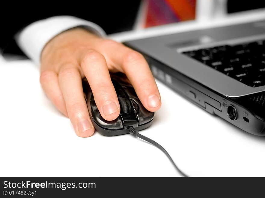 Businessman using a mouse and notebook