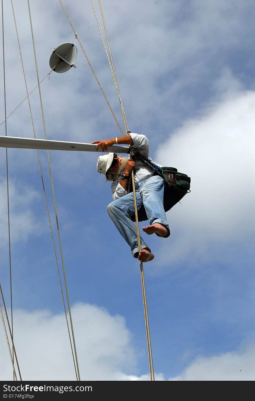 Senior man, marine surveyor, inspecting spreader on sailboat. Senior man, marine surveyor, inspecting spreader on sailboat.