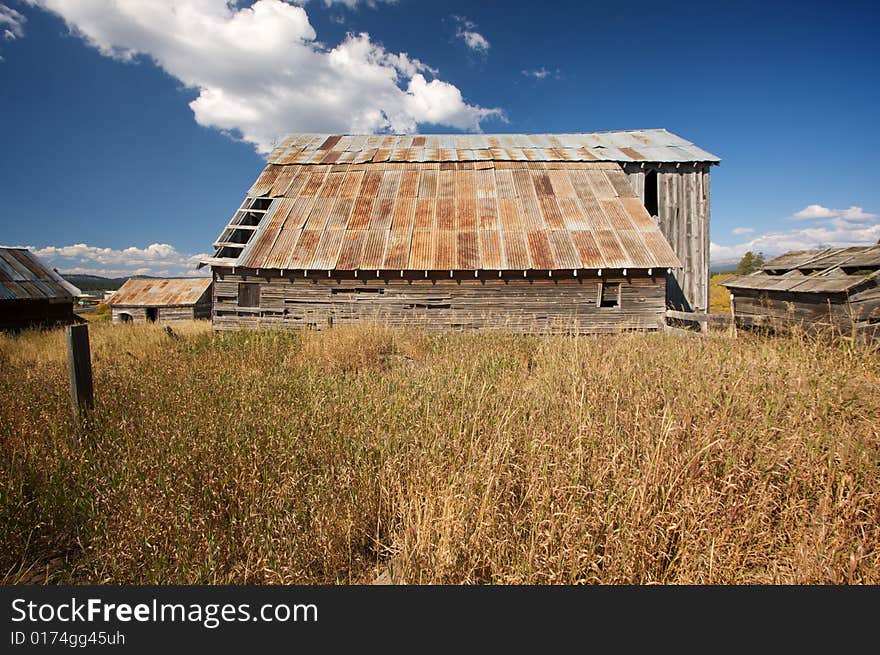 Rustic Barn Scene with Deep Blue Sky and Clouds