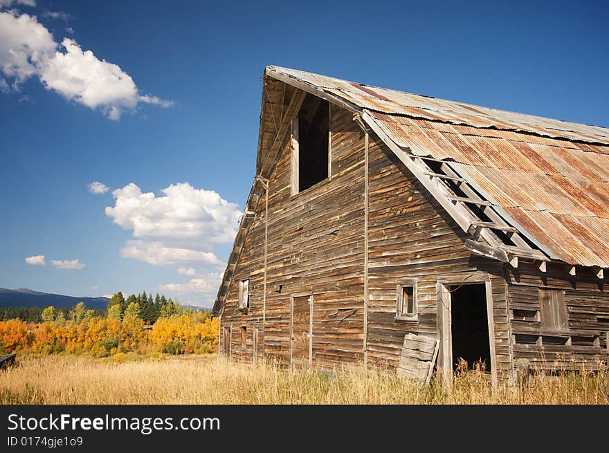 Rustic Barn Scene with Deep Blue Sky and Clouds