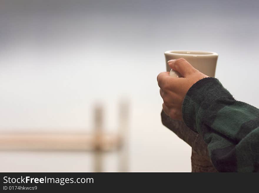 Woman Enjoys Morning Cup Coffee on the Lake. Woman Enjoys Morning Cup Coffee on the Lake.