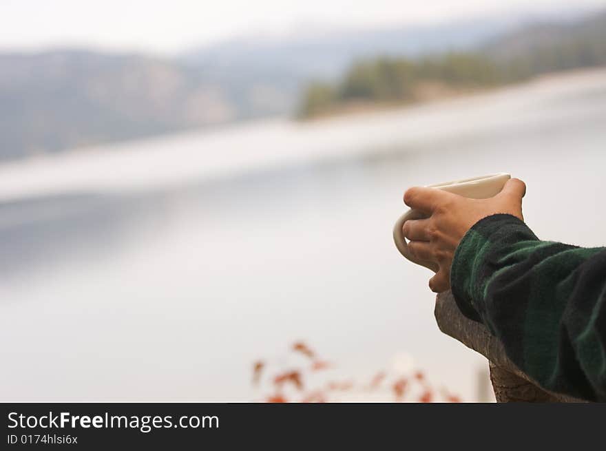 Woman Enjoys Morning Cup Coffee on the Lake. Woman Enjoys Morning Cup Coffee on the Lake.