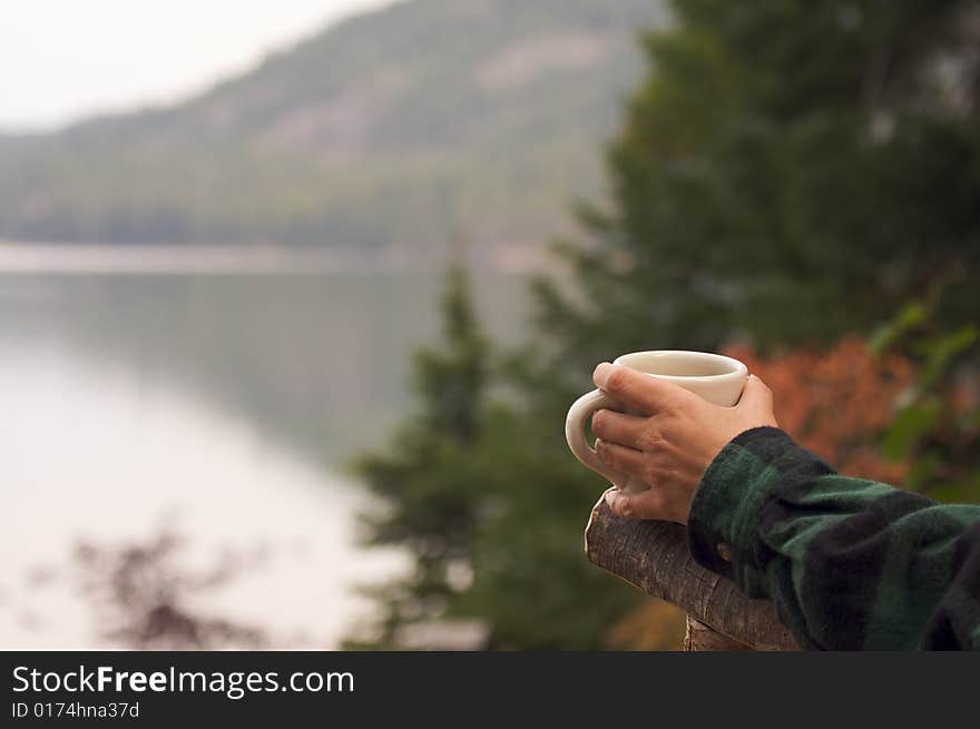 Woman Enjoys Morning Cup Coffee on the Lake. Woman Enjoys Morning Cup Coffee on the Lake.