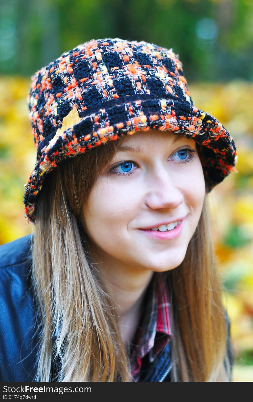 Autumn portrait of the pretty girl in park