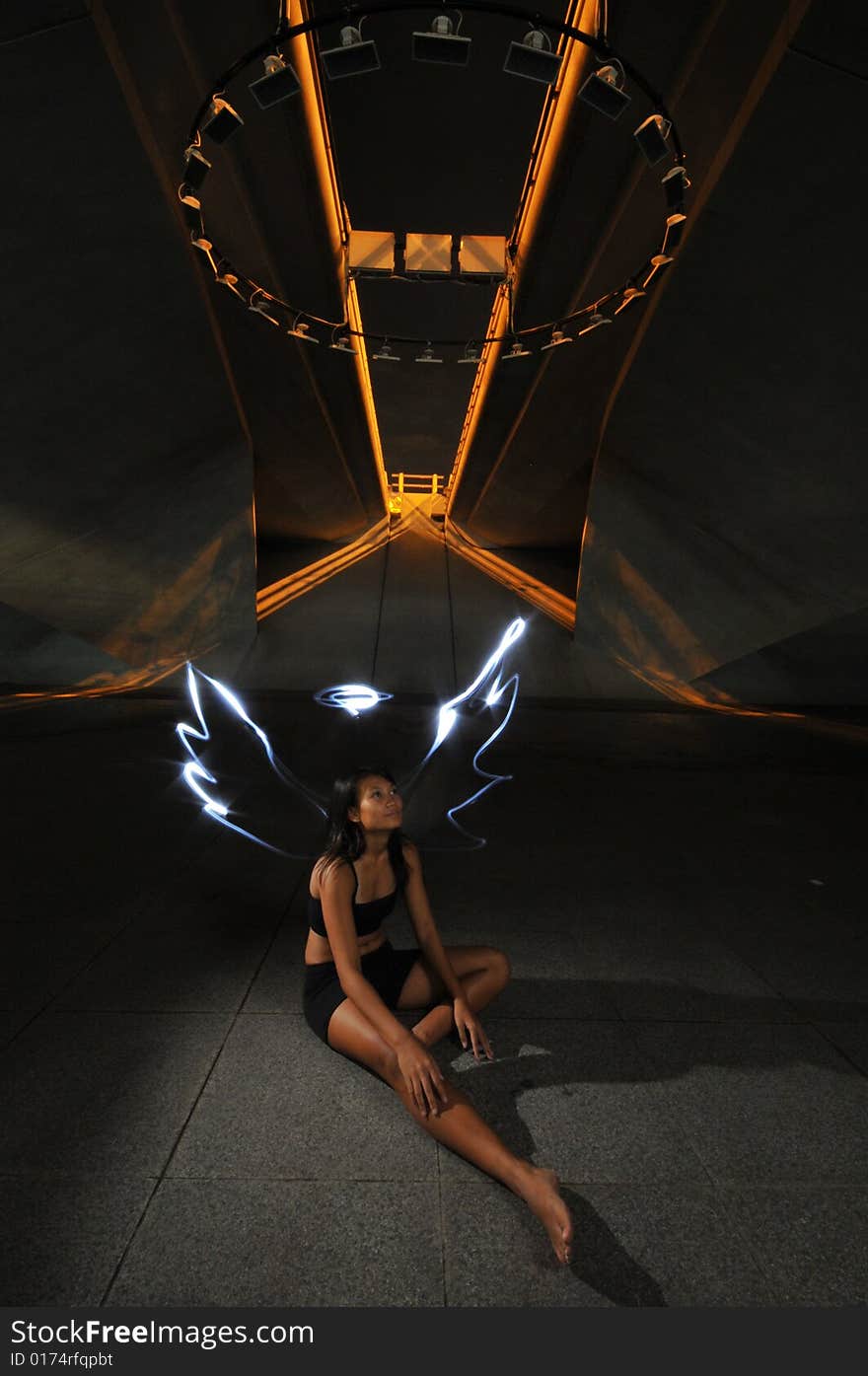 Artistic Picture of a Dancer standing under athletic equipment, painted with light to look like angle wings and halo. Artistic Picture of a Dancer standing under athletic equipment, painted with light to look like angle wings and halo.