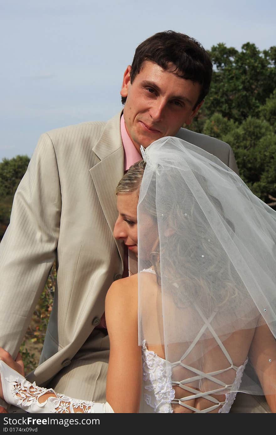 Bride and groom together in sunny day. Bride and groom together in sunny day.