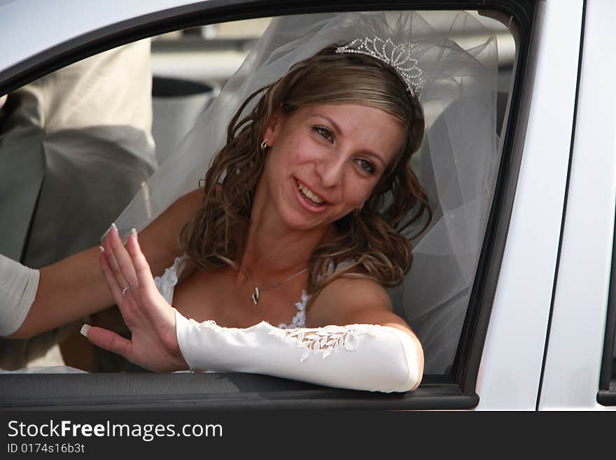 Happy bride in the car