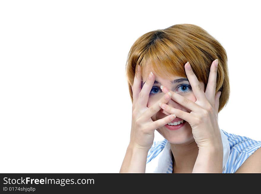 Foxy young smiling woman closes face by hands, isolated on white