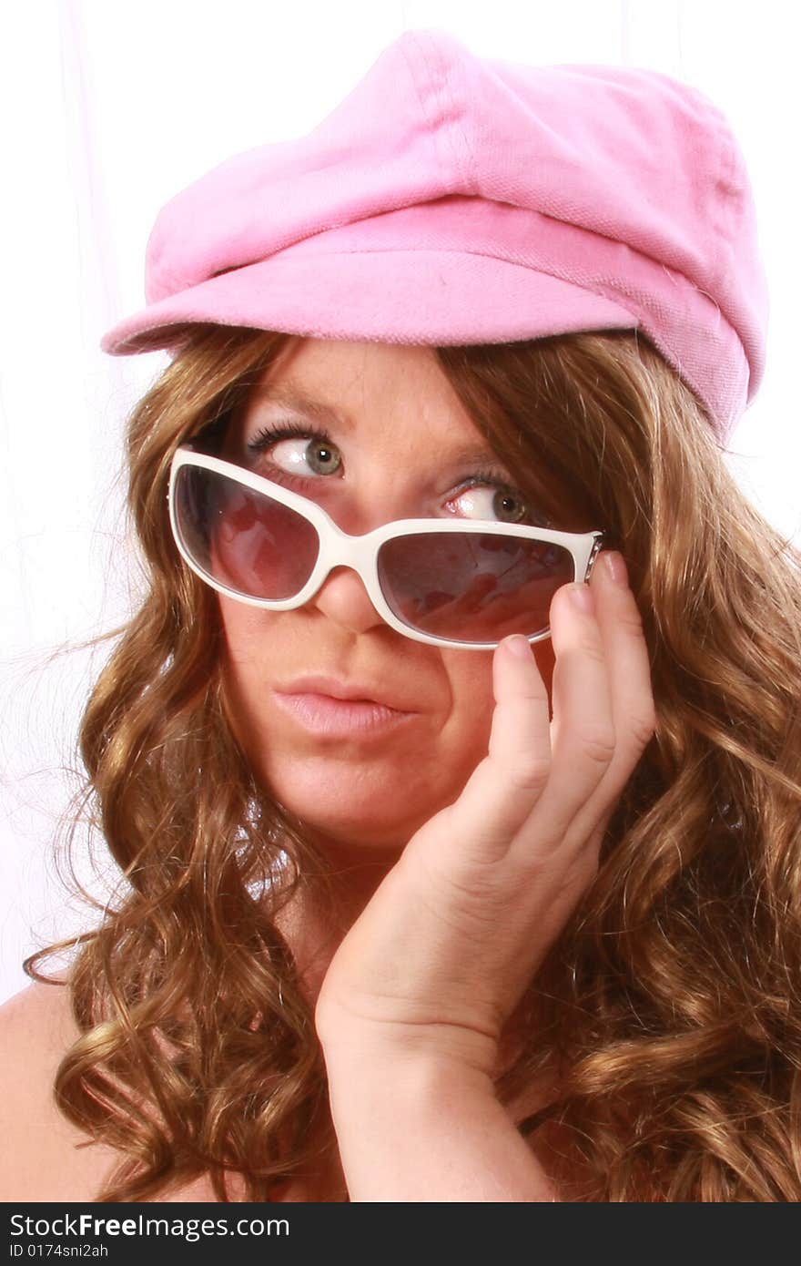 Women wearing a pink hat with sunglasses. Women wearing a pink hat with sunglasses