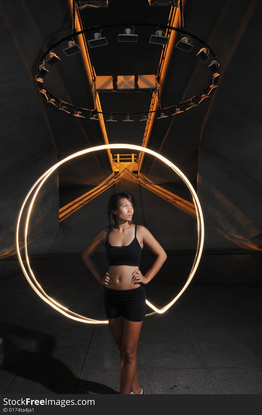 Artistic Picture of an athlete standing under athletic equipment, painted with light. Artistic Picture of an athlete standing under athletic equipment, painted with light.