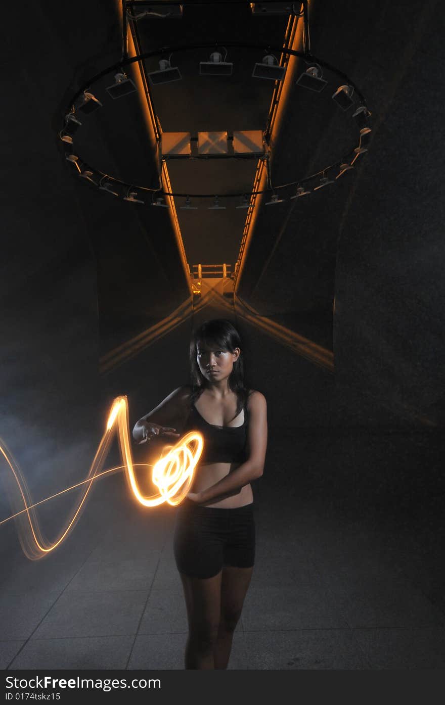 Artistic Picture of a Dancer standing under circle of lights with light painting. Artistic Picture of a Dancer standing under circle of lights with light painting.