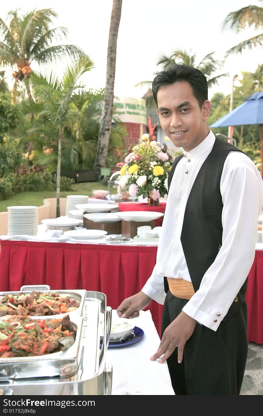 Waiter at buffet outdoor smiling