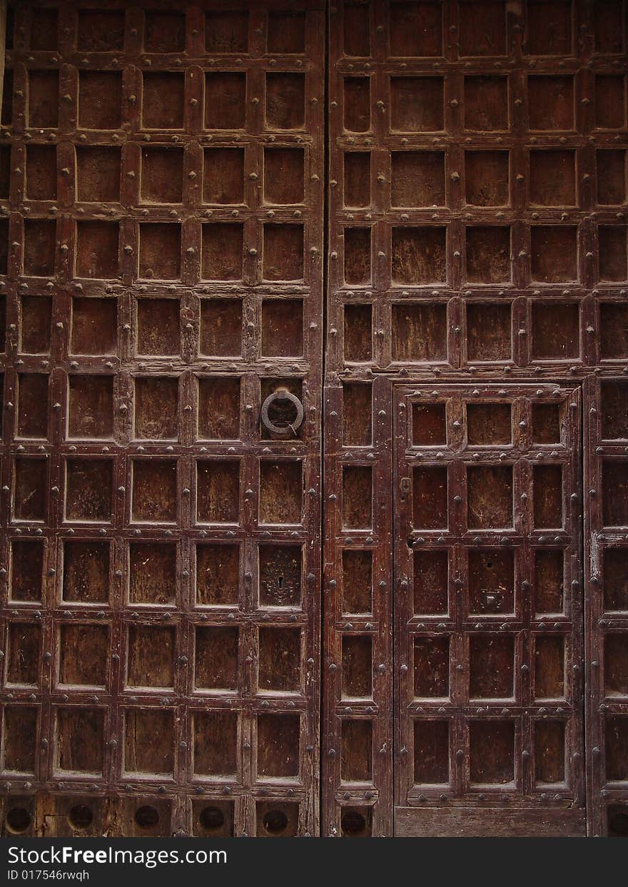 Old brown door with grating decor. Old brown door with grating decor