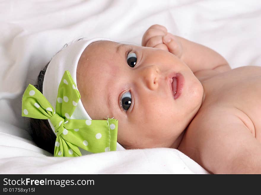 Cute baby girl in beautiful white-green  bow