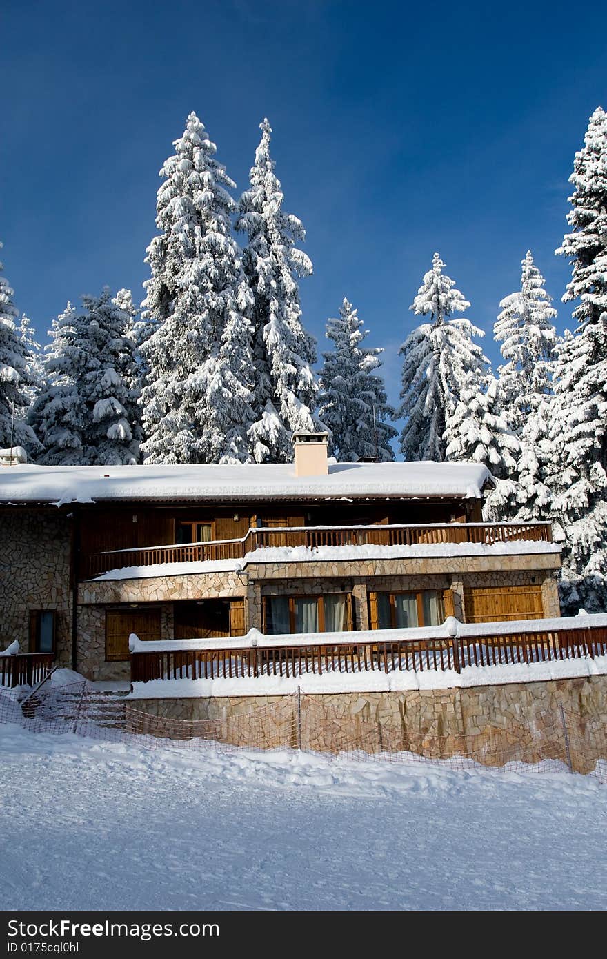 Isolated mountain cottage near trees covered by fresh snow. Isolated mountain cottage near trees covered by fresh snow