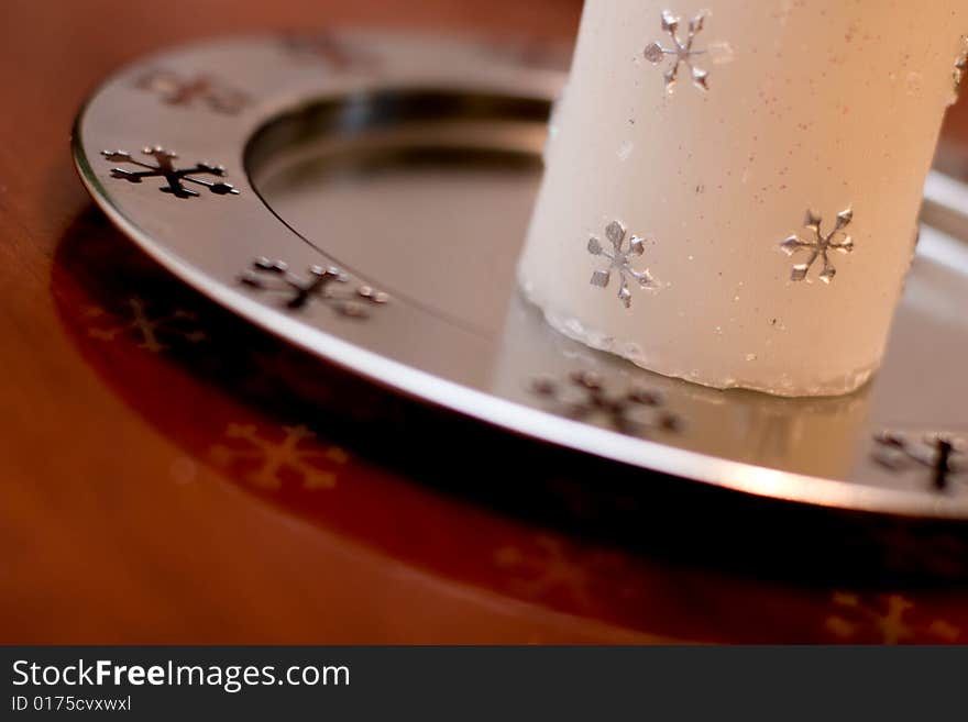 Christmas white candle detail with silver snowflakes