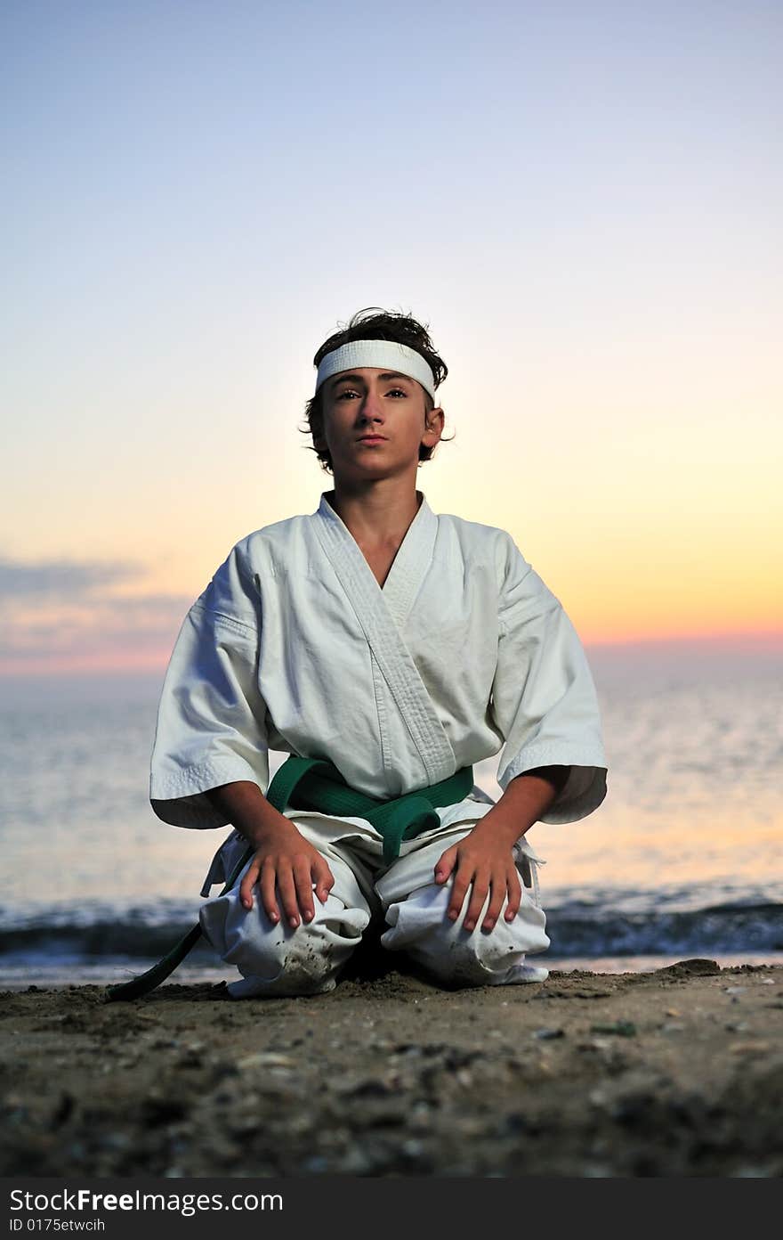 Young boy in karate uniform standing in seiza position. Young boy in karate uniform standing in seiza position