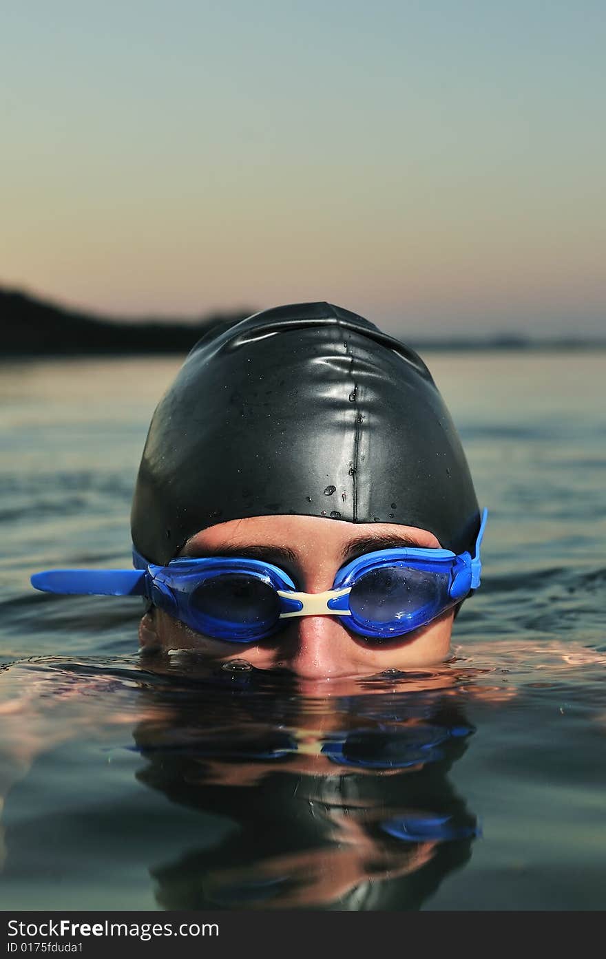 A young boy swimming in sea, close up. A young boy swimming in sea, close up