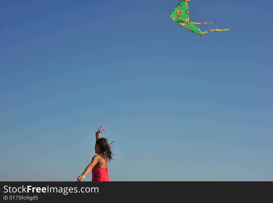 Little girl running and flying a kite. Little girl running and flying a kite