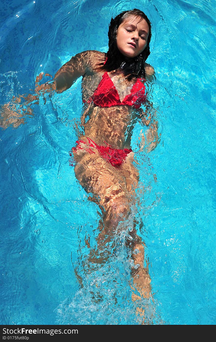 Top view of a girl swimming in pool