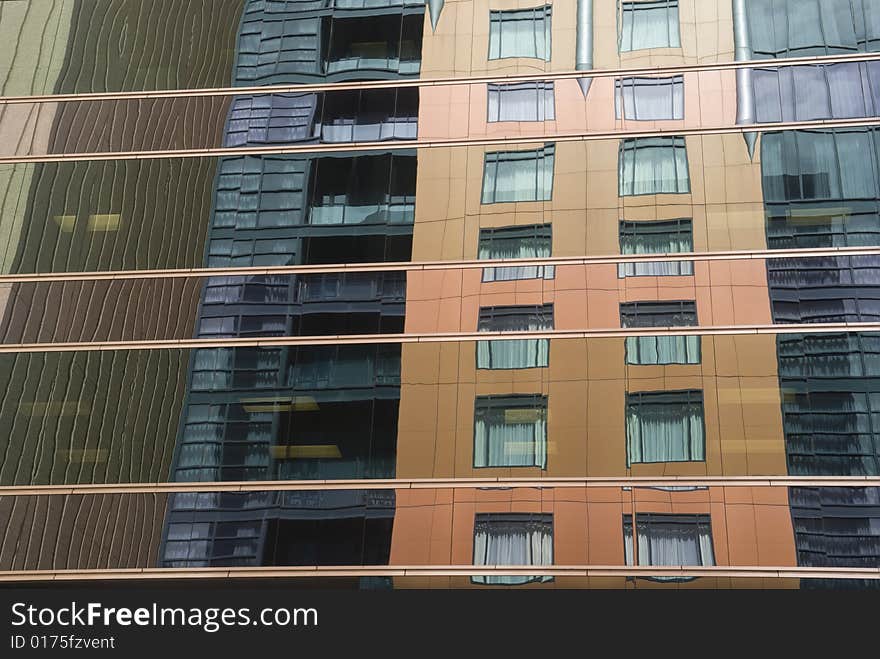 Reflections of nearby buildings in the glass of an office building. Reflections of nearby buildings in the glass of an office building