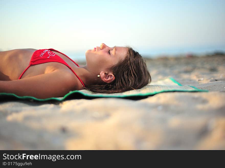 Little girl lying on the beach, close up. Little girl lying on the beach, close up