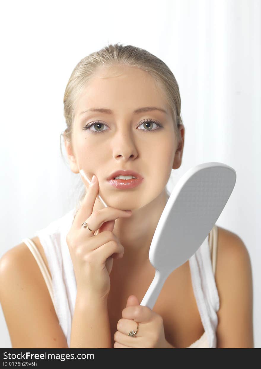 Young, beautiful female putting a makeup on. Young, beautiful female putting a makeup on