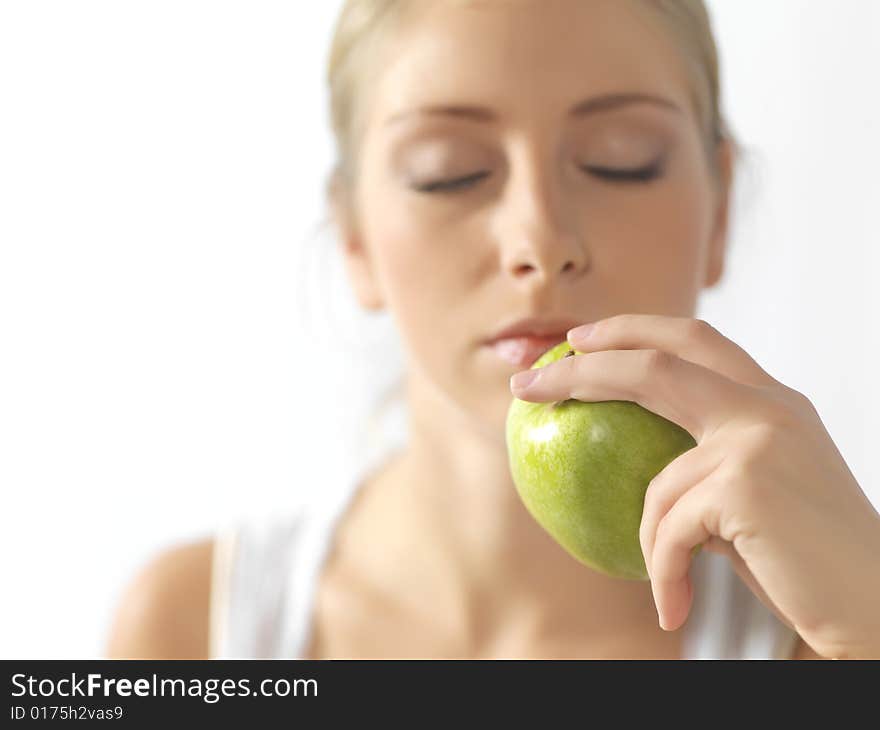 Young, beautiful female eating an apple. Young, beautiful female eating an apple