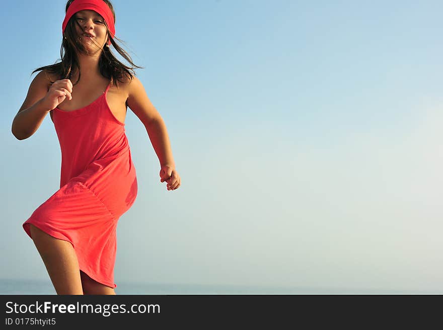 Young girl in red dress dancing in nature. Young girl in red dress dancing in nature