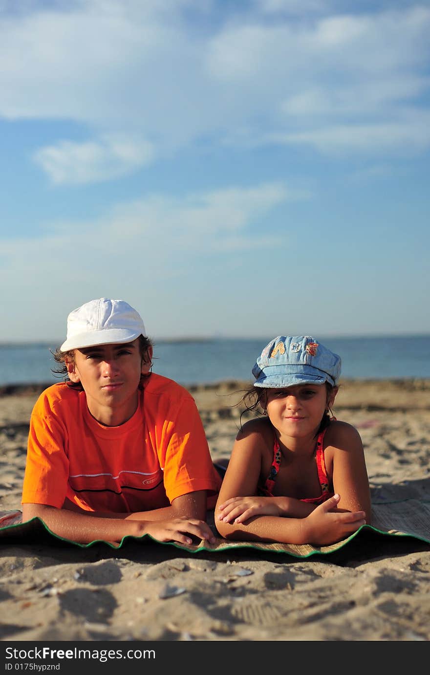 A boy and a girl standing on beach. A boy and a girl standing on beach