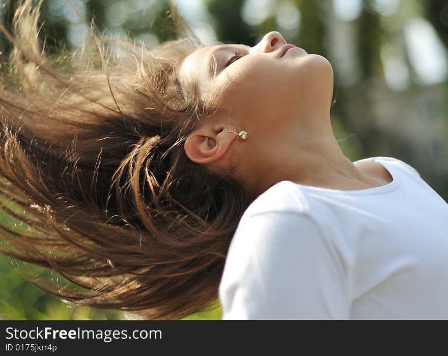 Close up portrait of young girl flipping hair