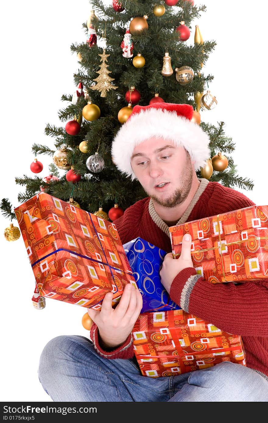 Happy man with gifts over christmas tree. Happy man with gifts over christmas tree