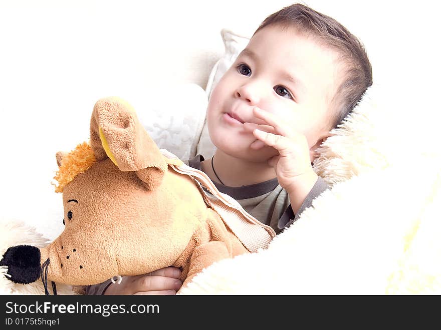 Portrait of a little happy kid with toys