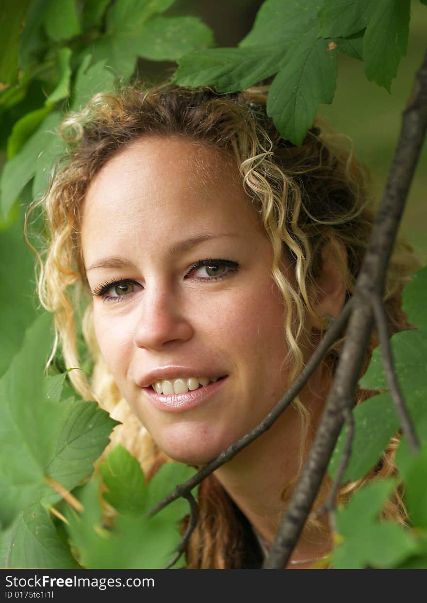 Curly girl face detail surrounded by maple leaves