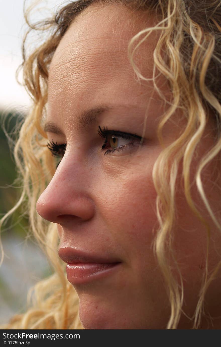 Curly girl face detail in outdoor