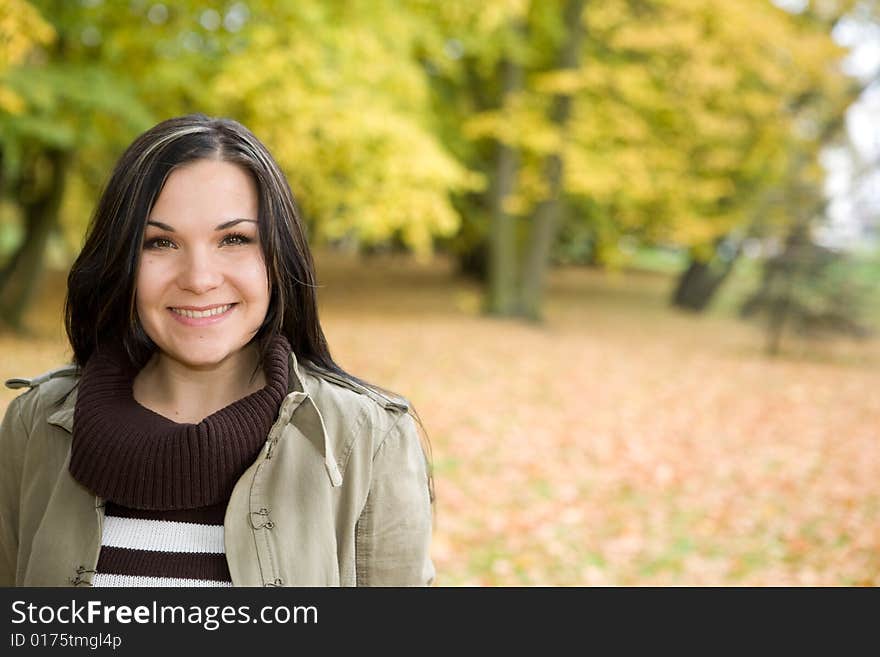 Happy brunette woman relaxing in park. Happy brunette woman relaxing in park