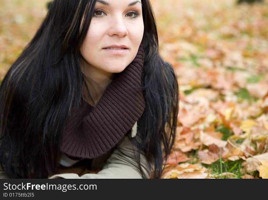 Happy brunette woman relaxing in park. Happy brunette woman relaxing in park