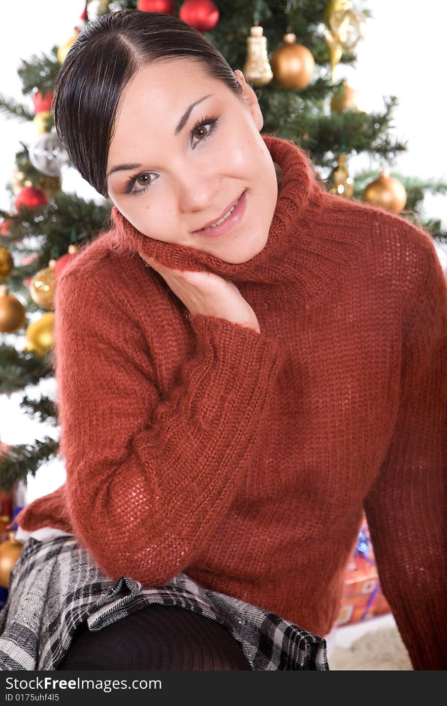 Happy brunette woman over christmas tree. Happy brunette woman over christmas tree