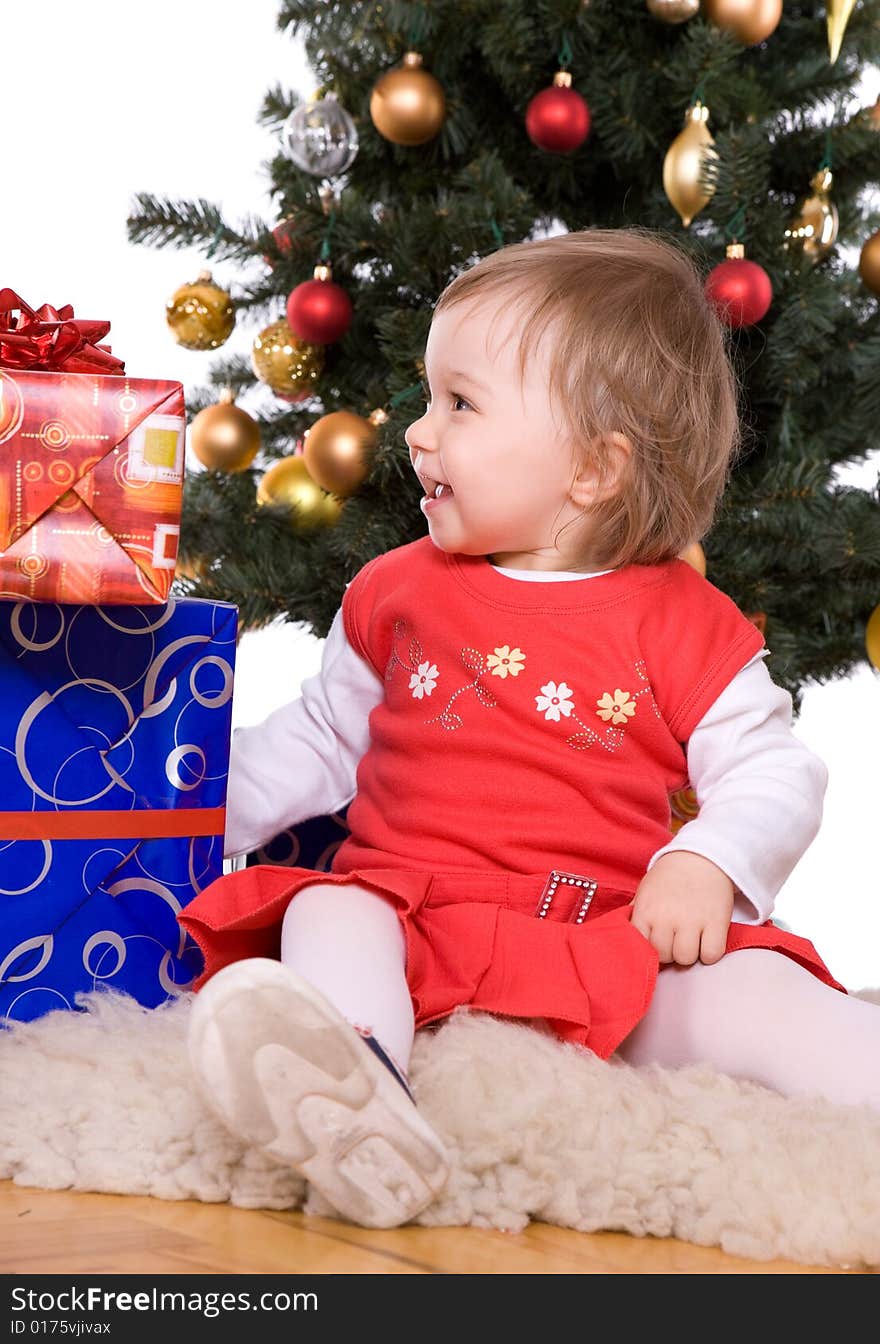 Cute baby girl over christmas tree. Cute baby girl over christmas tree