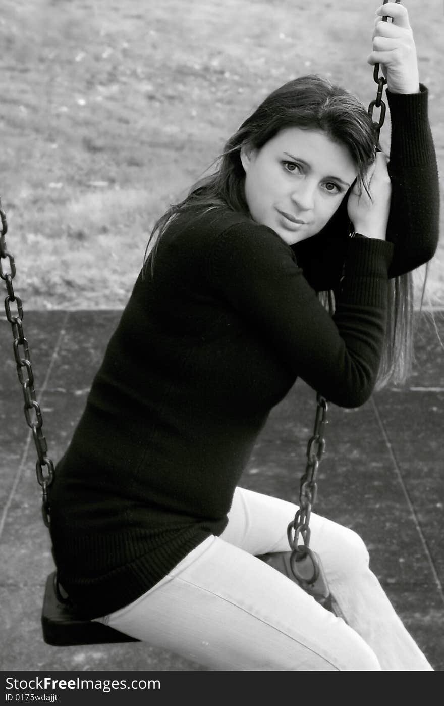 Black and white image of pretty young female on a swing. Black and white image of pretty young female on a swing