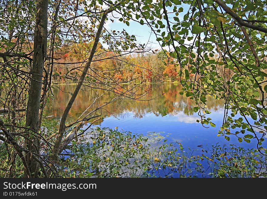 Fall trees relecting on sand lake in Chain O' Lakes State Park, Indiana. Fall trees relecting on sand lake in Chain O' Lakes State Park, Indiana