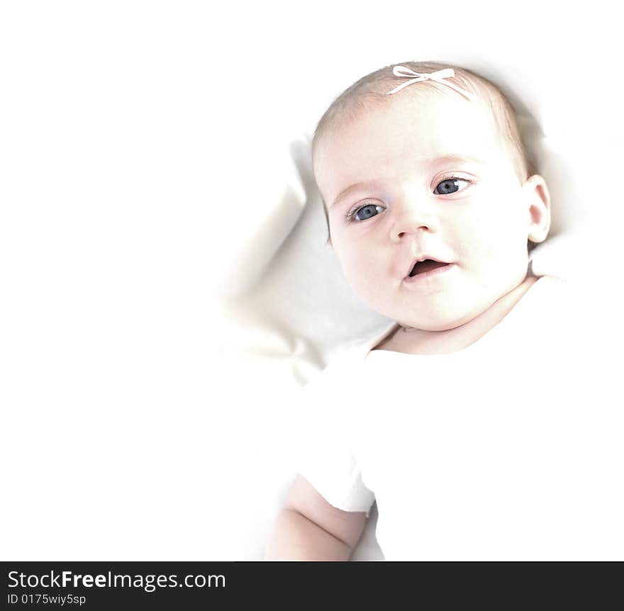 New born baby girl with bow lying on a white blanket. New born baby girl with bow lying on a white blanket