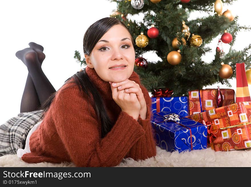 Happy brunette woman over christmas tree. Happy brunette woman over christmas tree