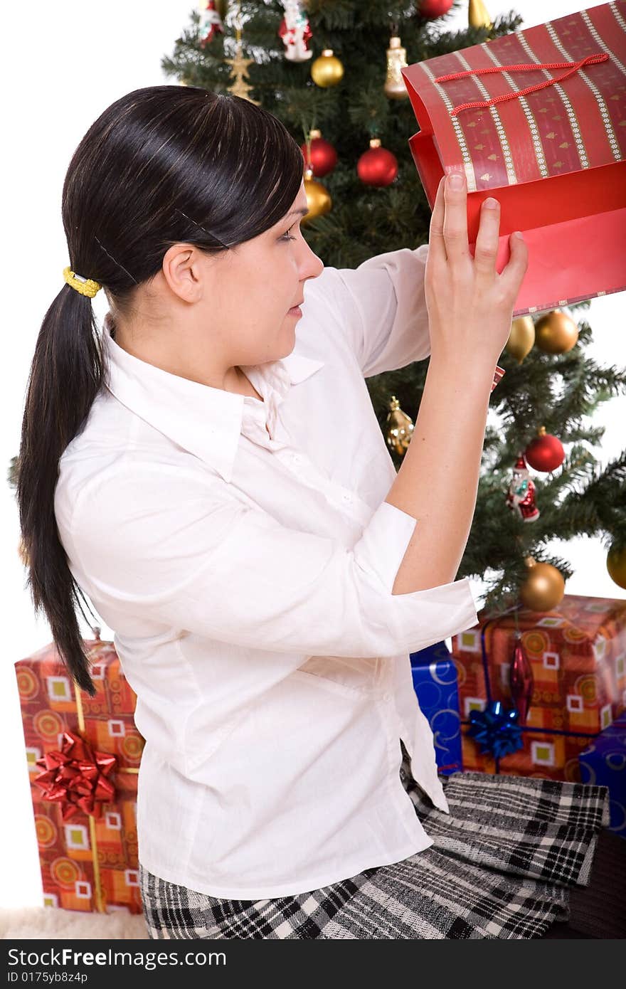 Happy brunette woman over christmas tree. Happy brunette woman over christmas tree