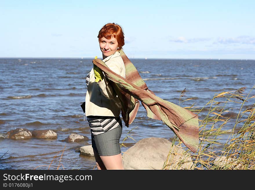 Red haired woman with scarf. Windy day.