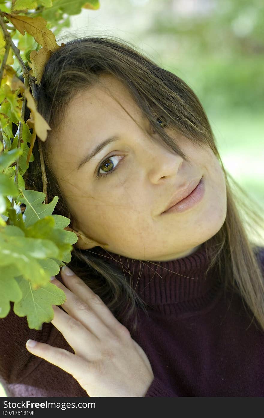 Pretty young woman against green leaves. Pretty young woman against green leaves