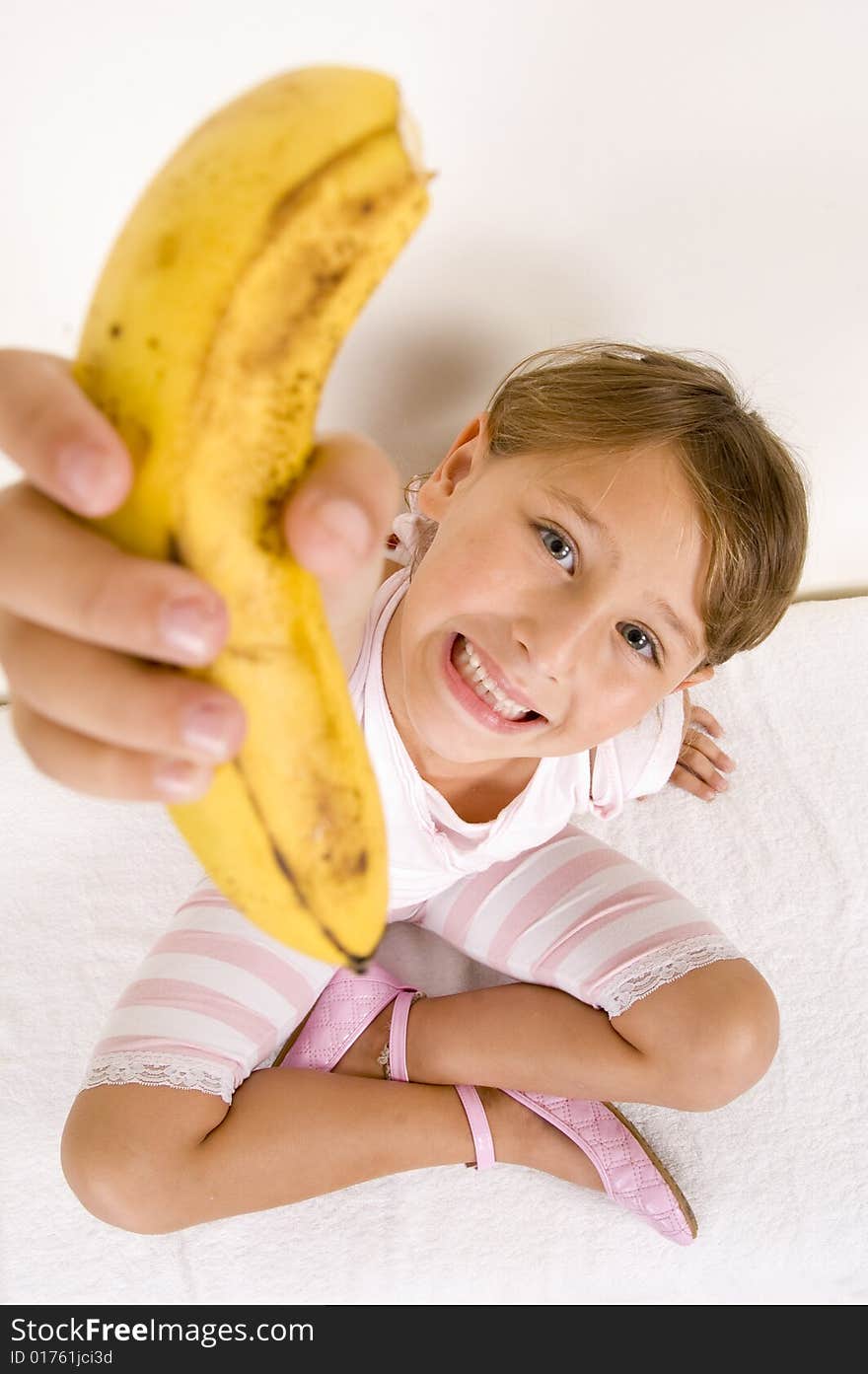 Little girl showing you banana