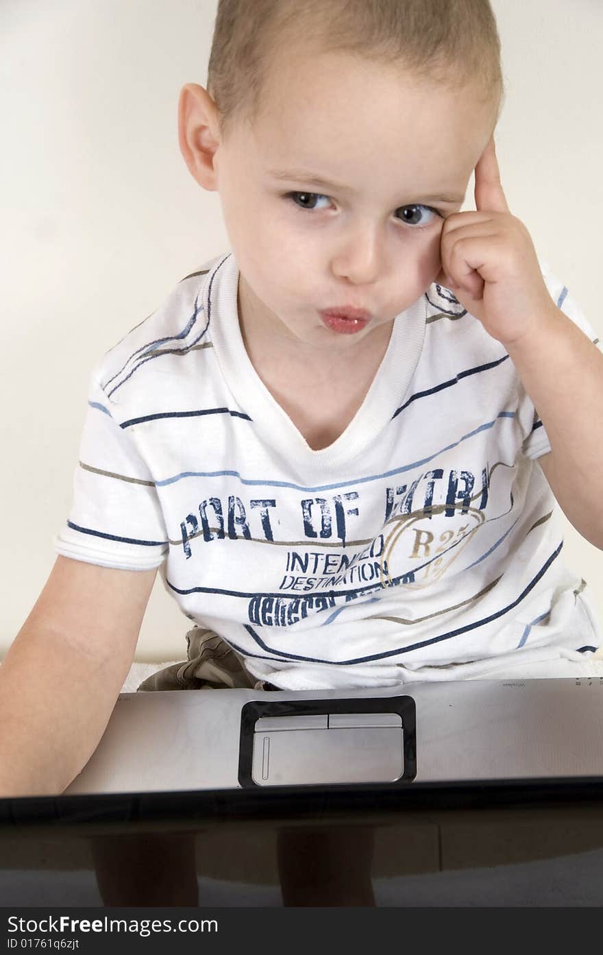 Little intellectual child with laptop