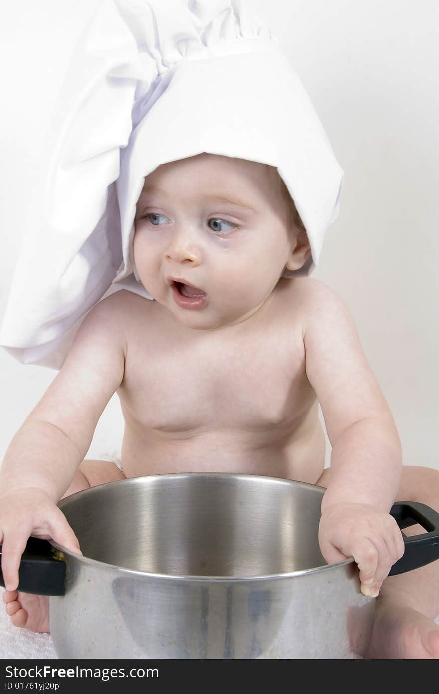 Little cute baby chef holding pan. Little cute baby chef holding pan