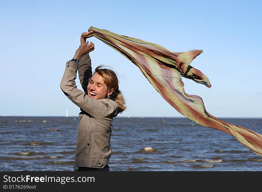 Blond woman with scarf. Windy day.